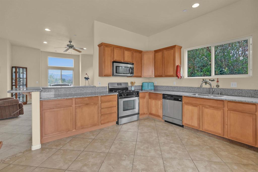 3431 Santa Saba Road Borrego Springs, CA 92004 - Photo 8 of 23 a kitchen with stainless steel appliances granite countertop a stove sink and cabinets
