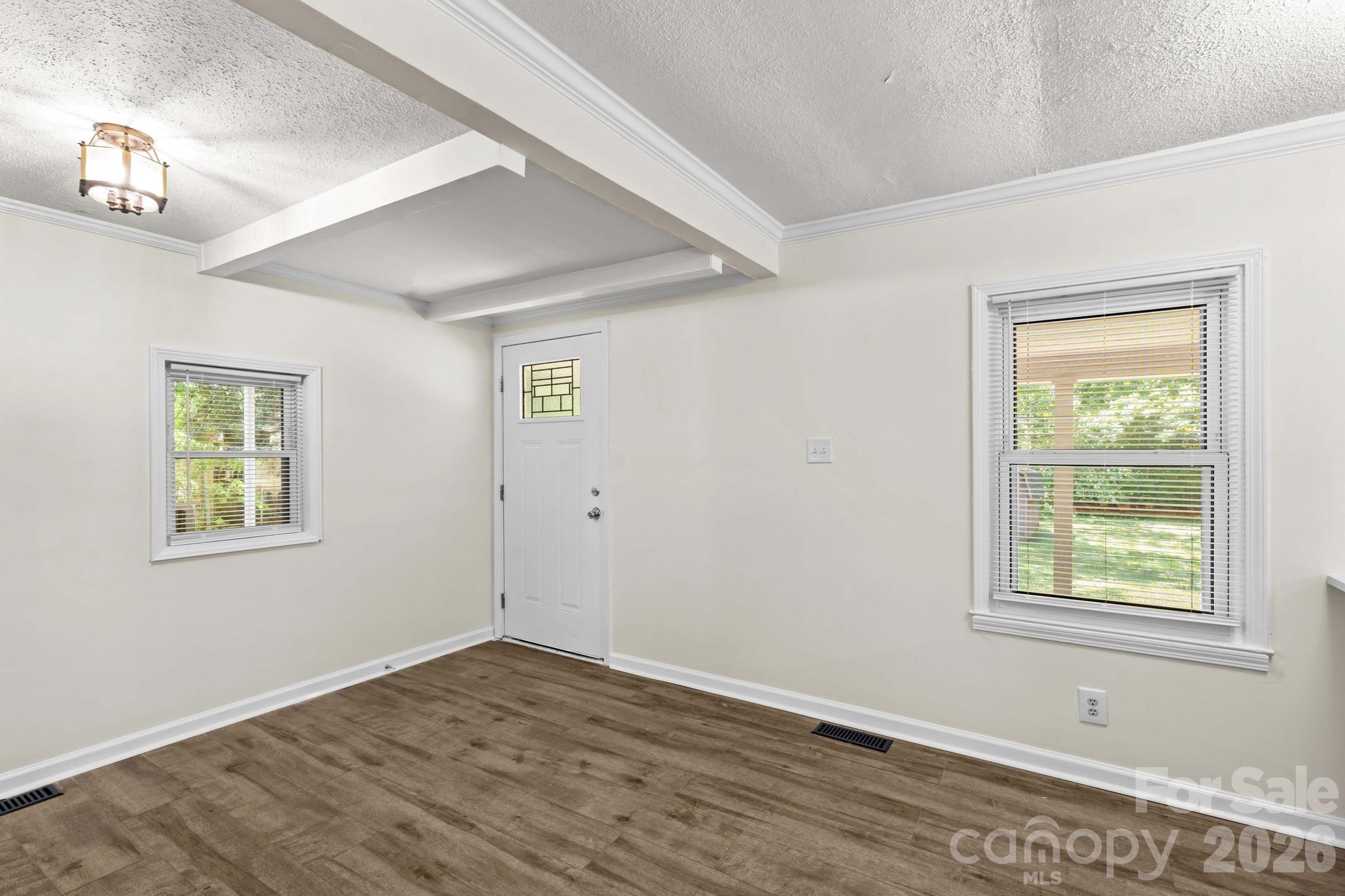 835 Maple Avenue Salisbury, NC 28144 - Photo 11 of 48 a view of an empty room with wooden floor and a window