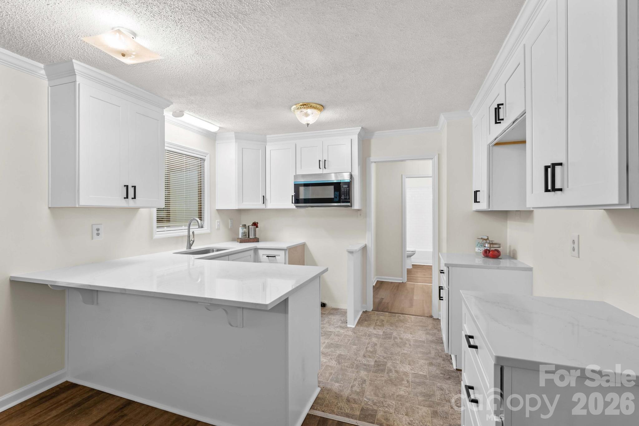 835 Maple Avenue Salisbury, NC 28144 - Photo 15 of 48 a kitchen with white cabinets and sink