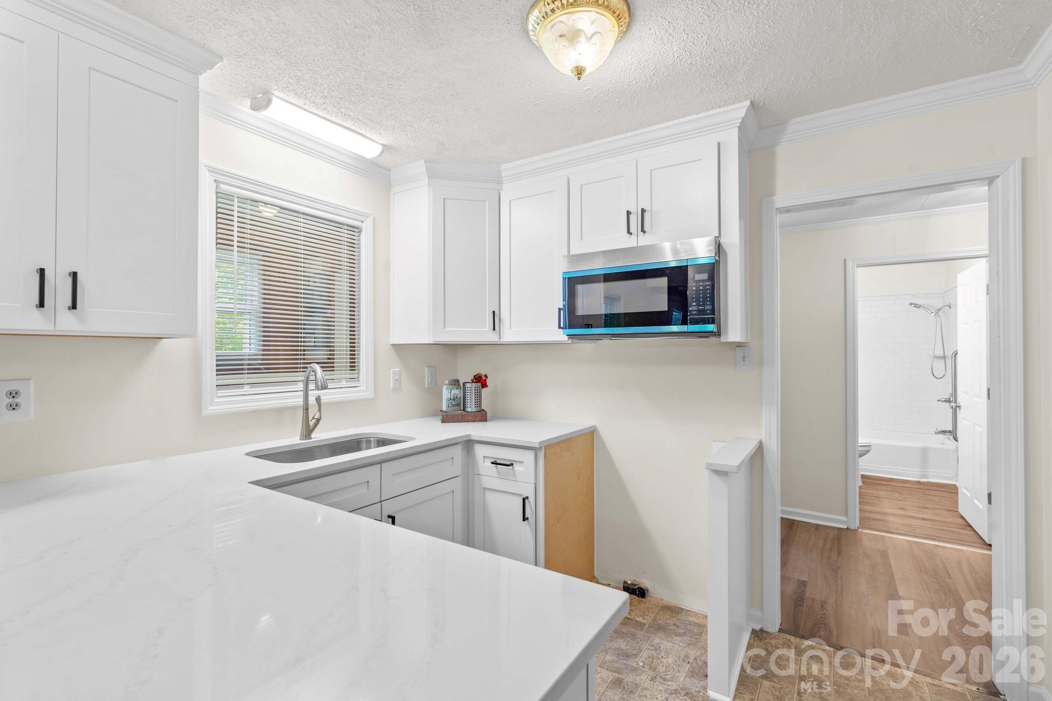 835 Maple Avenue Salisbury, NC 28144 - Photo 16 of 48 a kitchen with a sink a window and cabinets