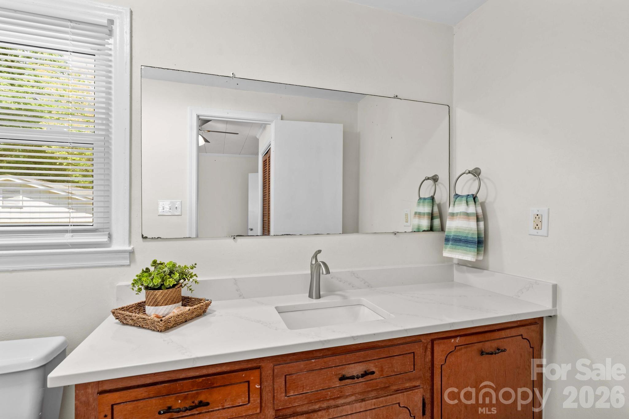 835 Maple Avenue Salisbury, NC 28144 - Photo 24 of 48 a bathroom with a sink a vanity and a mirror