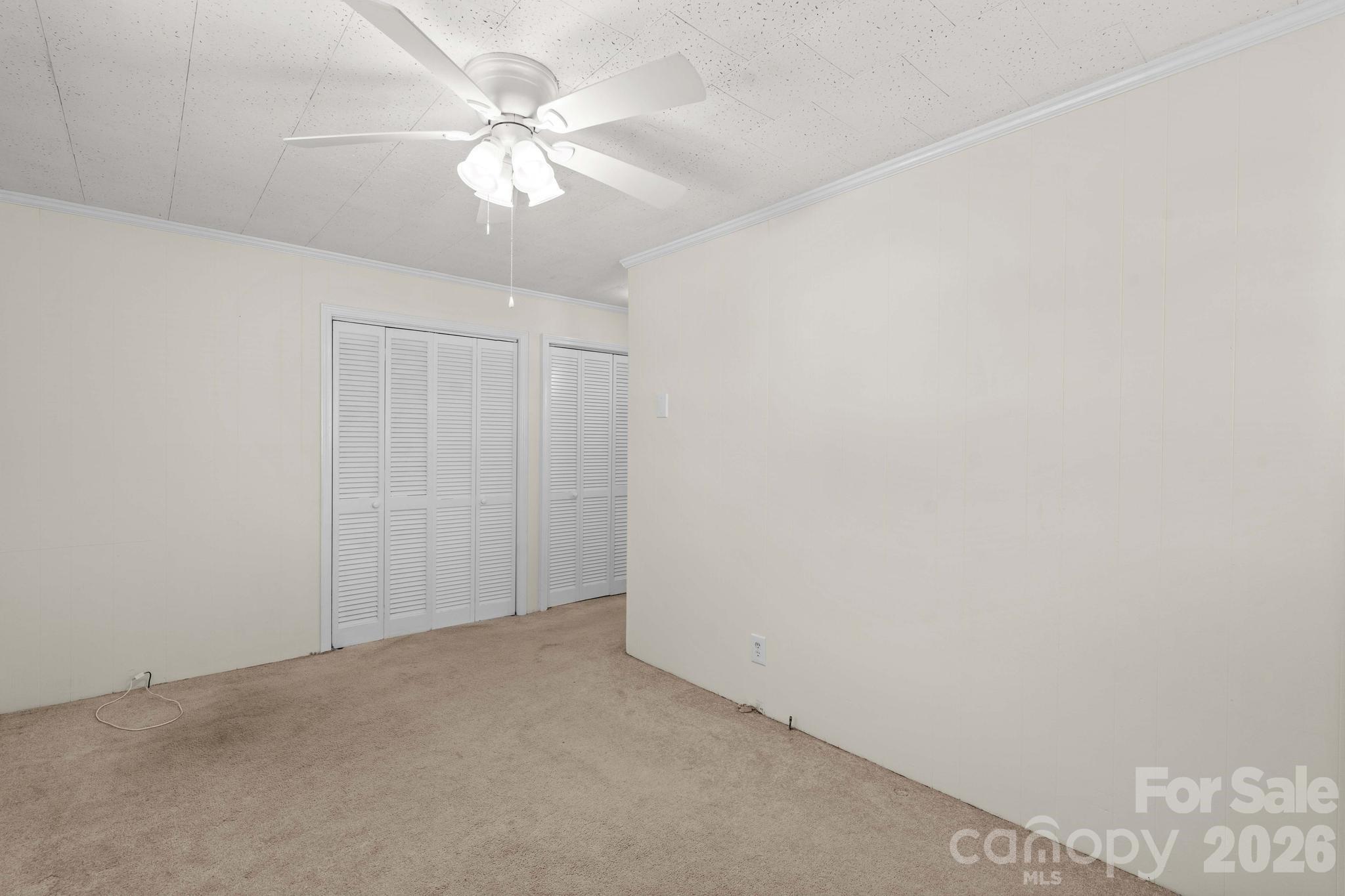 835 Maple Avenue Salisbury, NC 28144 - Photo 34 of 48 an empty room with a chandelier fan