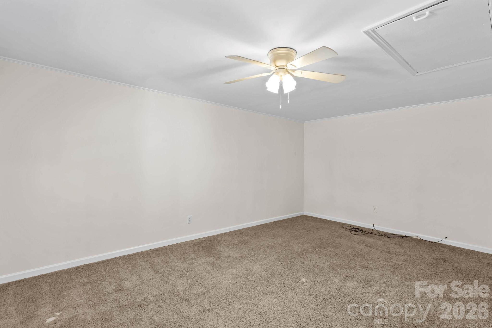 835 Maple Avenue Salisbury, NC 28144 - Photo 36 of 48 an empty room with a chandelier fan and windows