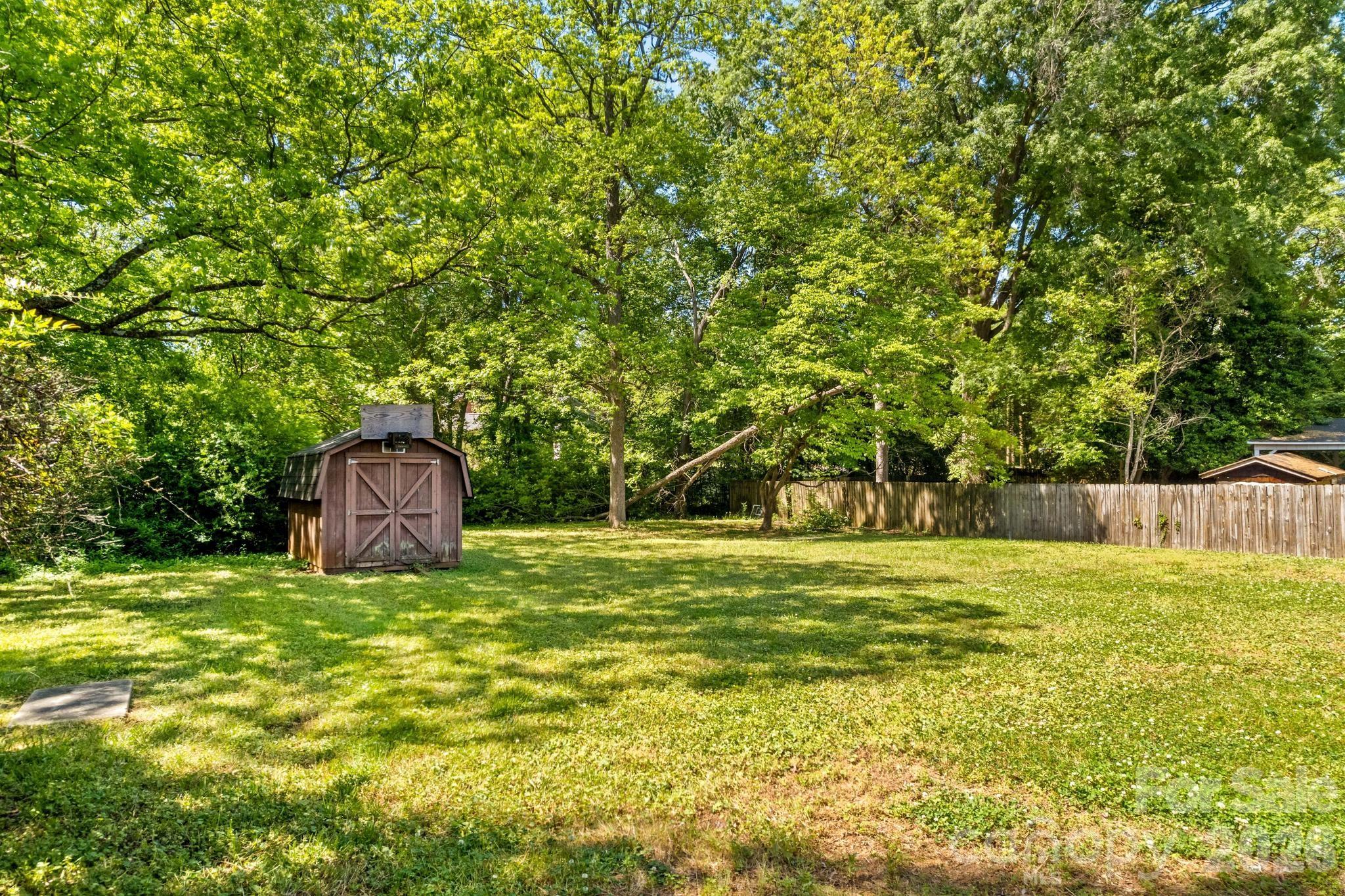 835 Maple Avenue Salisbury, NC 28144 - Photo 43 of 48 a view of a big yard with large trees and wooden fence