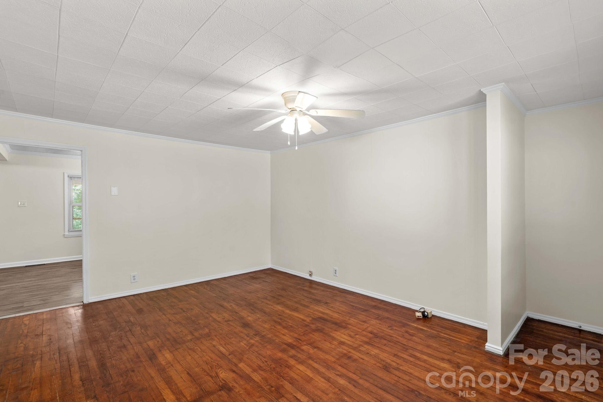 835 Maple Avenue Salisbury, NC 28144 - Photo 6 of 48 a view of a big room with wooden floor and a chandelier fan