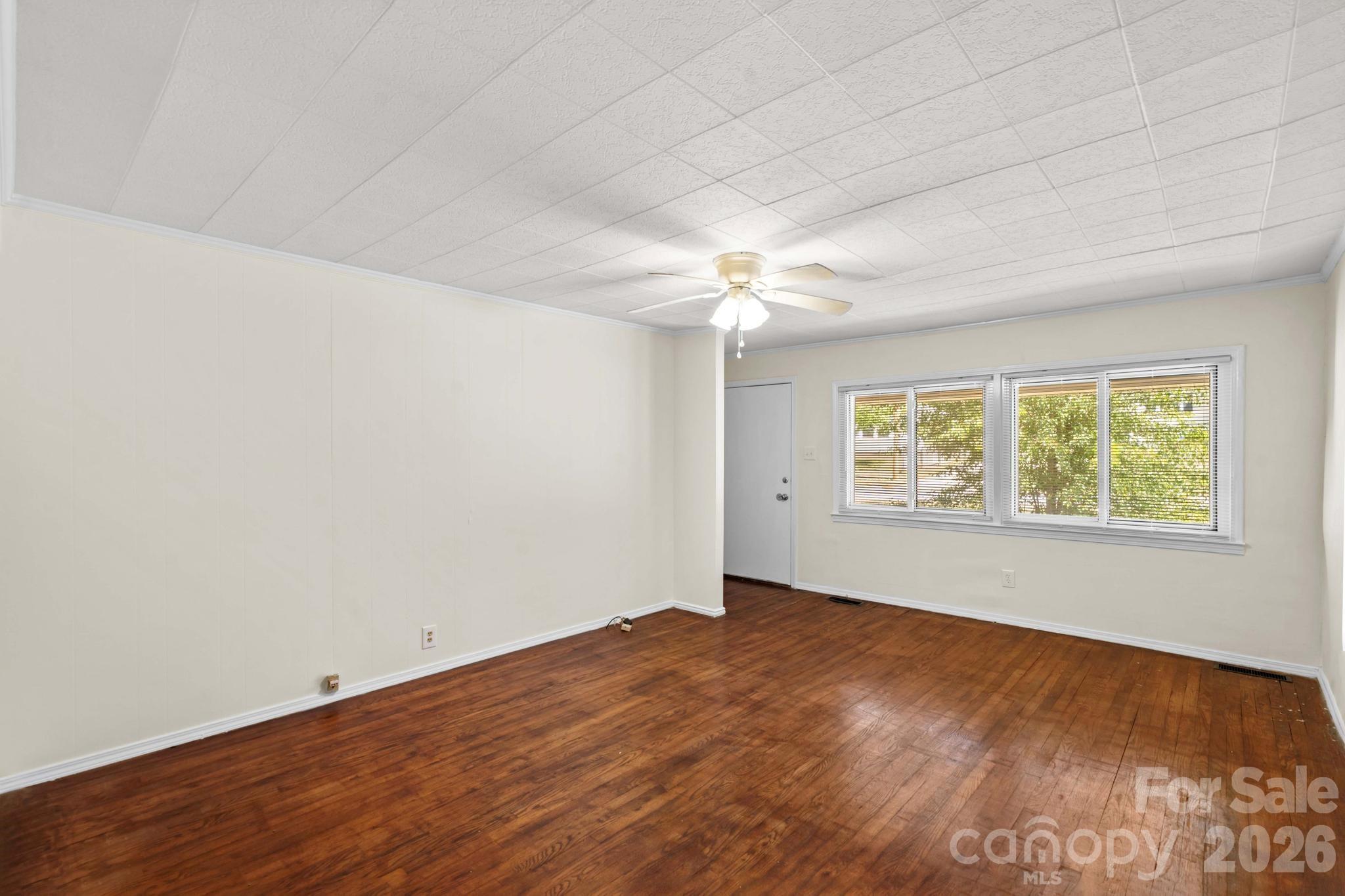 835 Maple Avenue Salisbury, NC 28144 - Photo 7 of 48 an empty room with wooden floor and windows