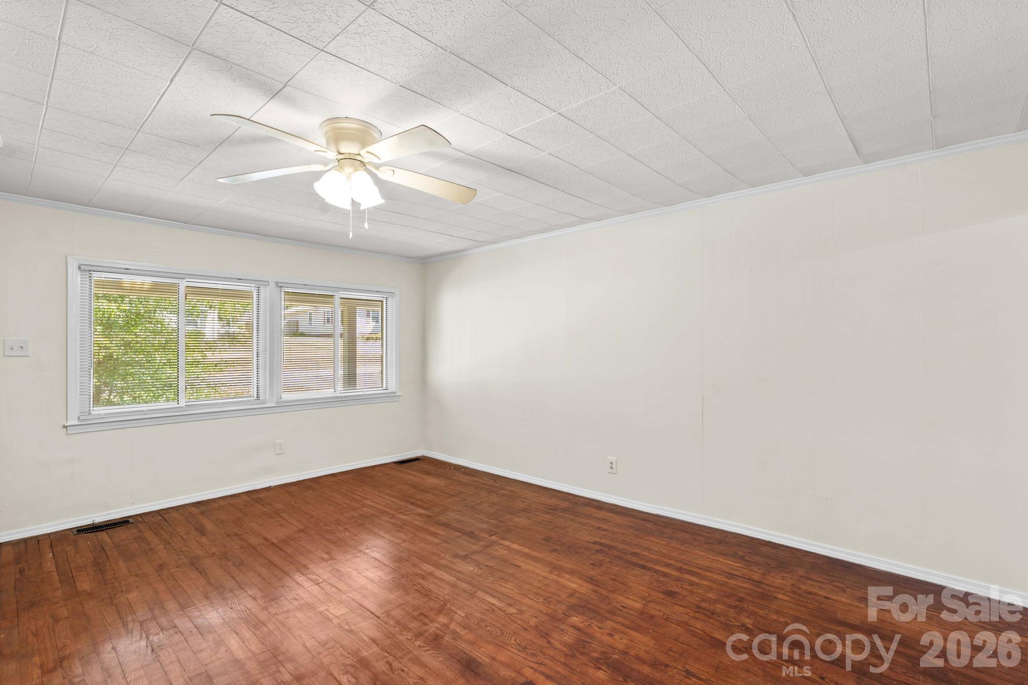 835 Maple Avenue Salisbury, NC 28144 - Photo 8 of 48 an empty room with a window and a fan