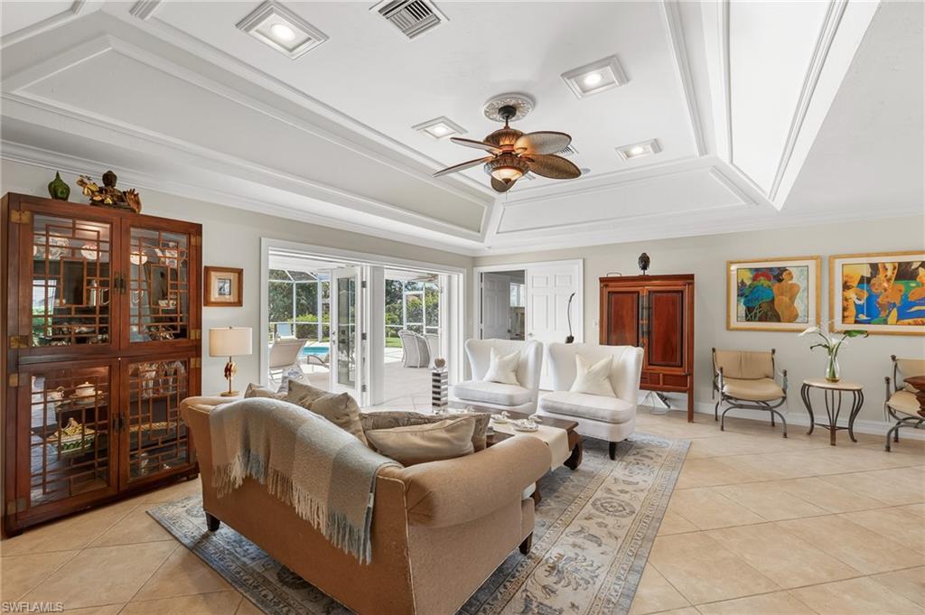 1904 Countess Court Naples, FL 34110 - Photo 7 of 33 a living room with furniture ceiling fan and a rug