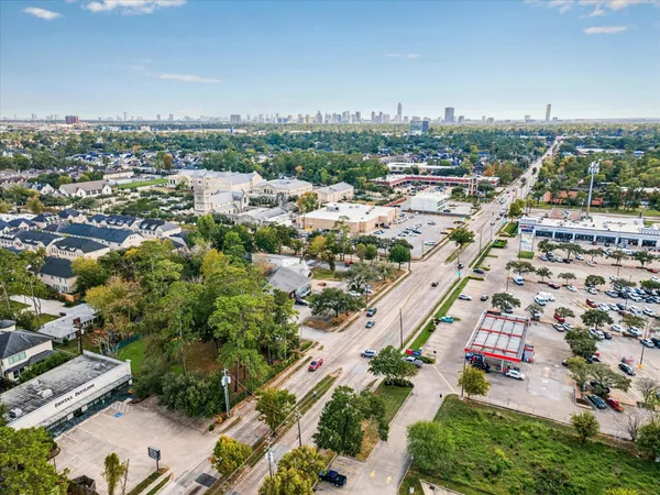 an aerial view of residential houses with city view