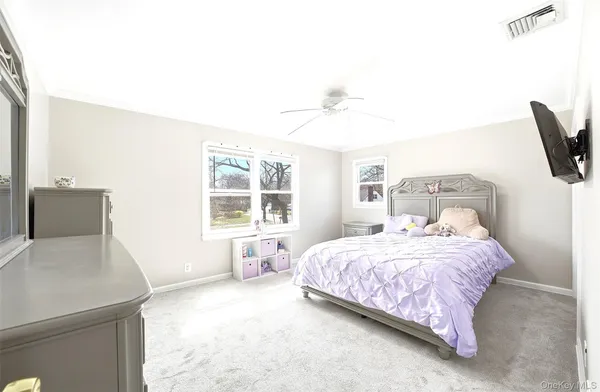 a bedroom with a bed and large window