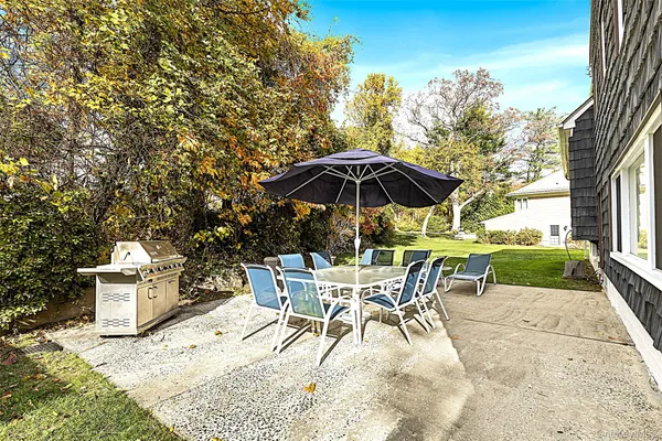 a patio with a yard table and chairs