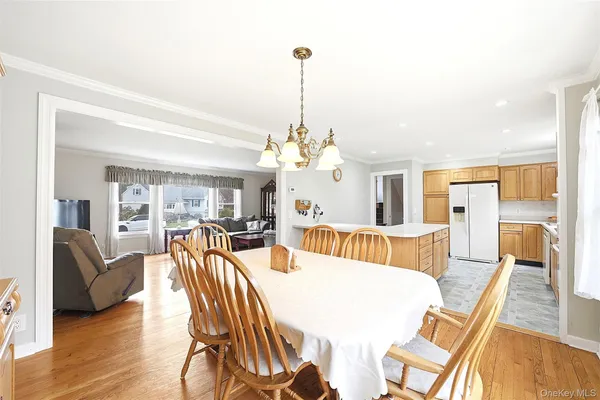 a view of a dining room with furniture wooden floor and chandelier