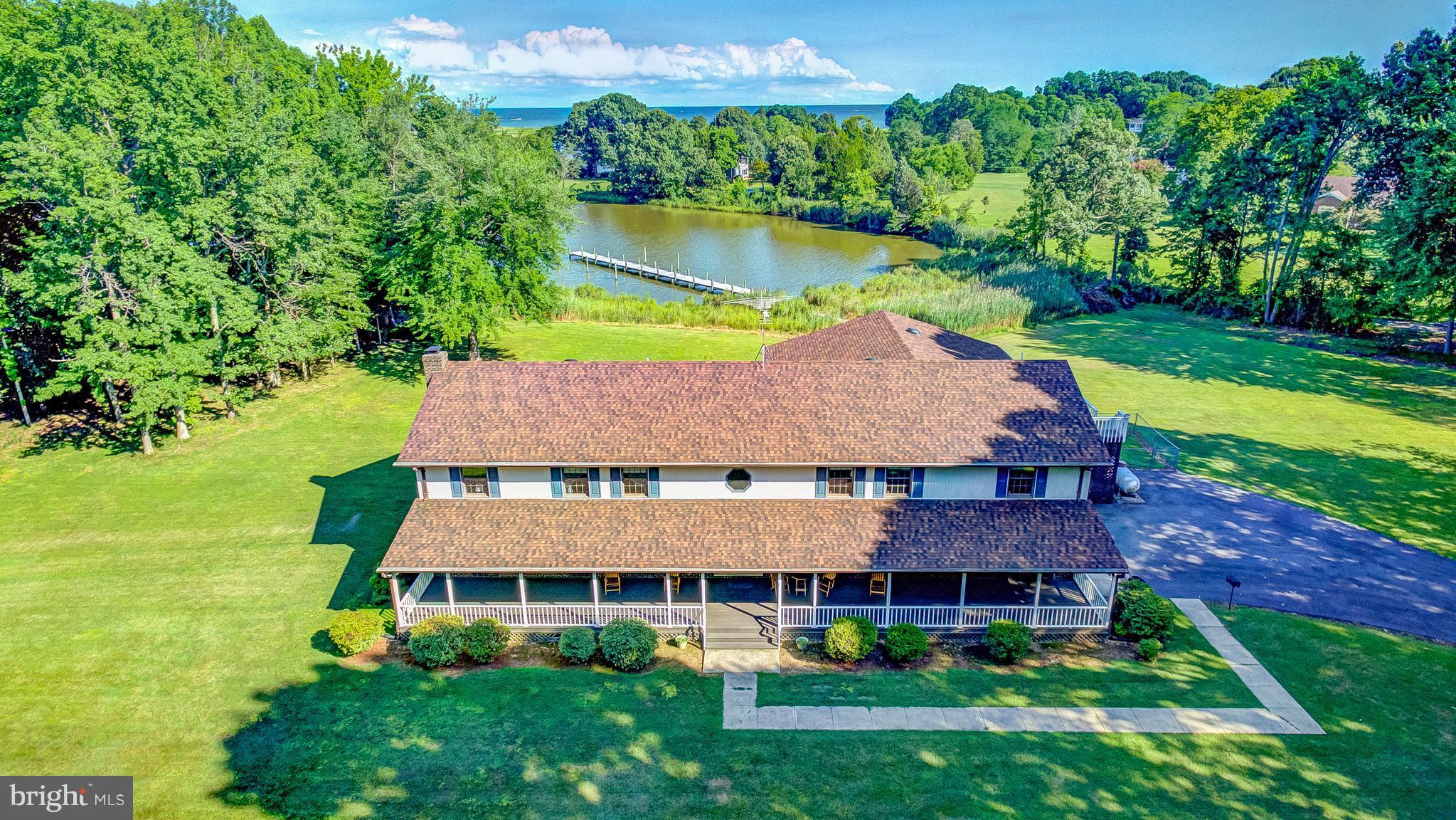 5966 Tyler Road Deale, MD 20751 - Photo 1 of 30 an aerial view of a house with a garden and lake view