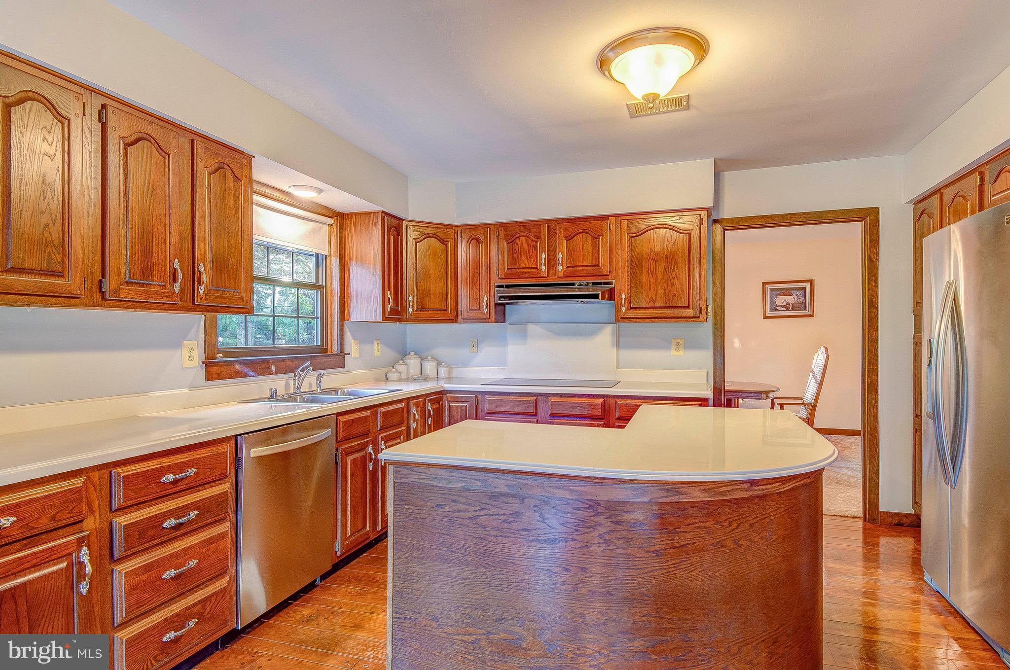 5966 Tyler Road Deale, MD 20751 - Photo 13 of 30 a room with stainless steel appliances granite countertop a sink a window and a counter space