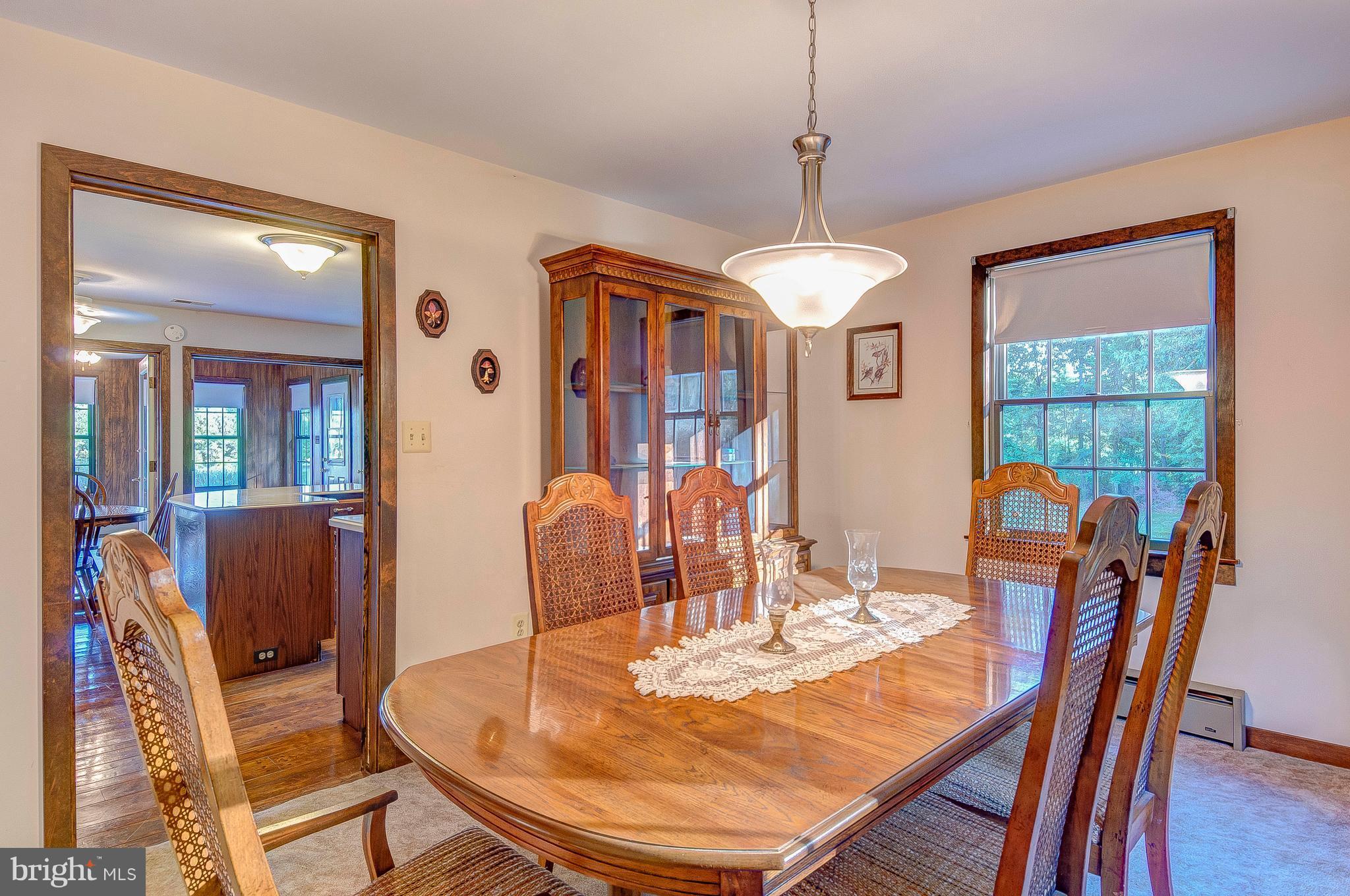 5966 Tyler Road Deale, MD 20751 - Photo 14 of 30 a dining room with furniture a chandelier and wooden floor