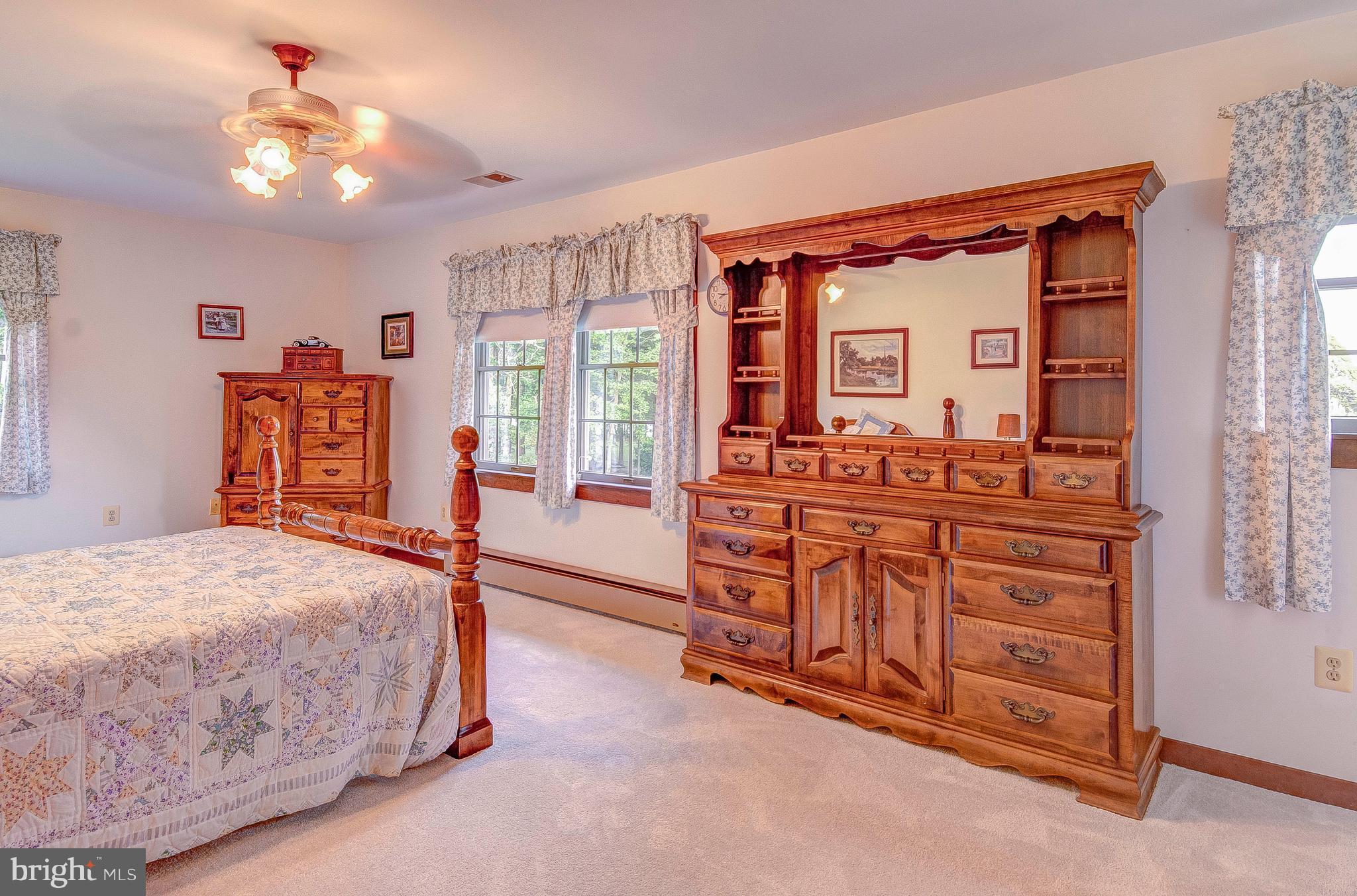 5966 Tyler Road Deale, MD 20751 - Photo 21 of 30 a bedroom with a bed and dresser with mirror