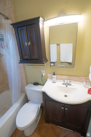 186 West Center Street Moab, UT 84532 - Photo 15 of 15 Bathroom featuring a white bathtub, a toilet, a vanity with a white integrated sink, a dark wood-finish cabinet, and a large mirror with overhead lighting