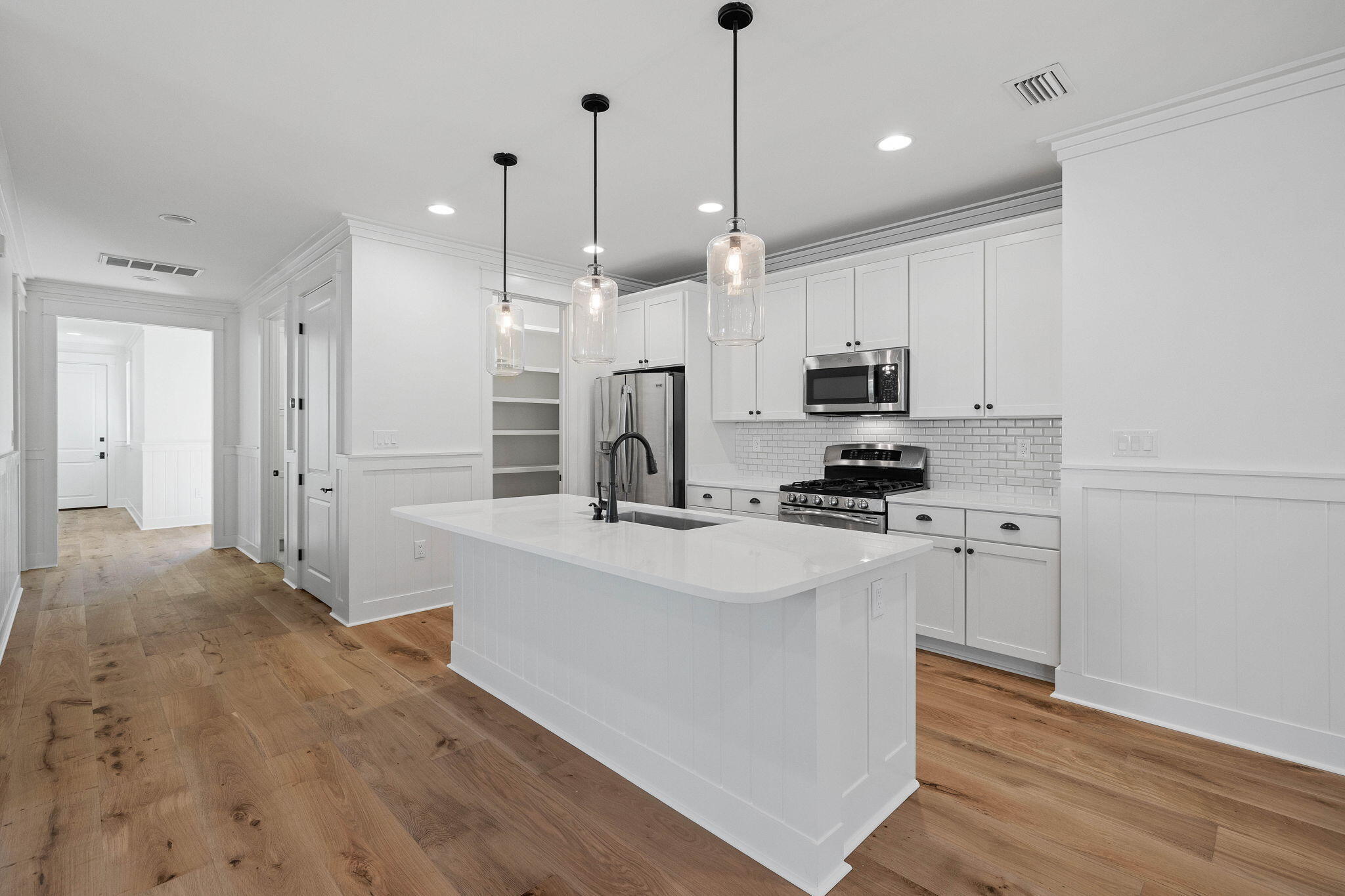 821 Breakers Street Inlet Beach, FL 32461 - Photo 28 of 69 a kitchen with stainless steel appliances kitchen island a white cabinets and a chandelier