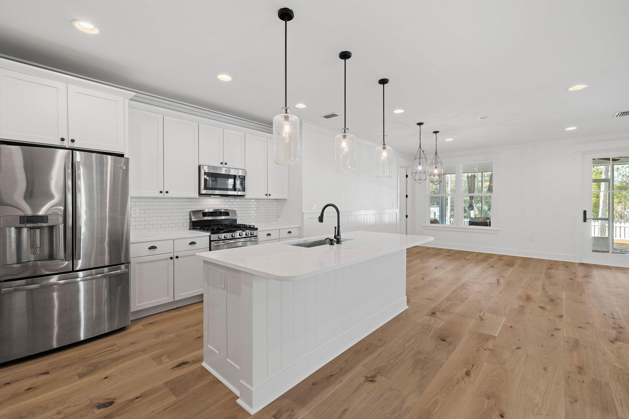 821 Breakers Street Inlet Beach, FL 32461 - Photo 30 of 69 a kitchen with stainless steel appliances granite countertop a refrigerator a sink dishwasher a stove and white cabinets with wooden floor