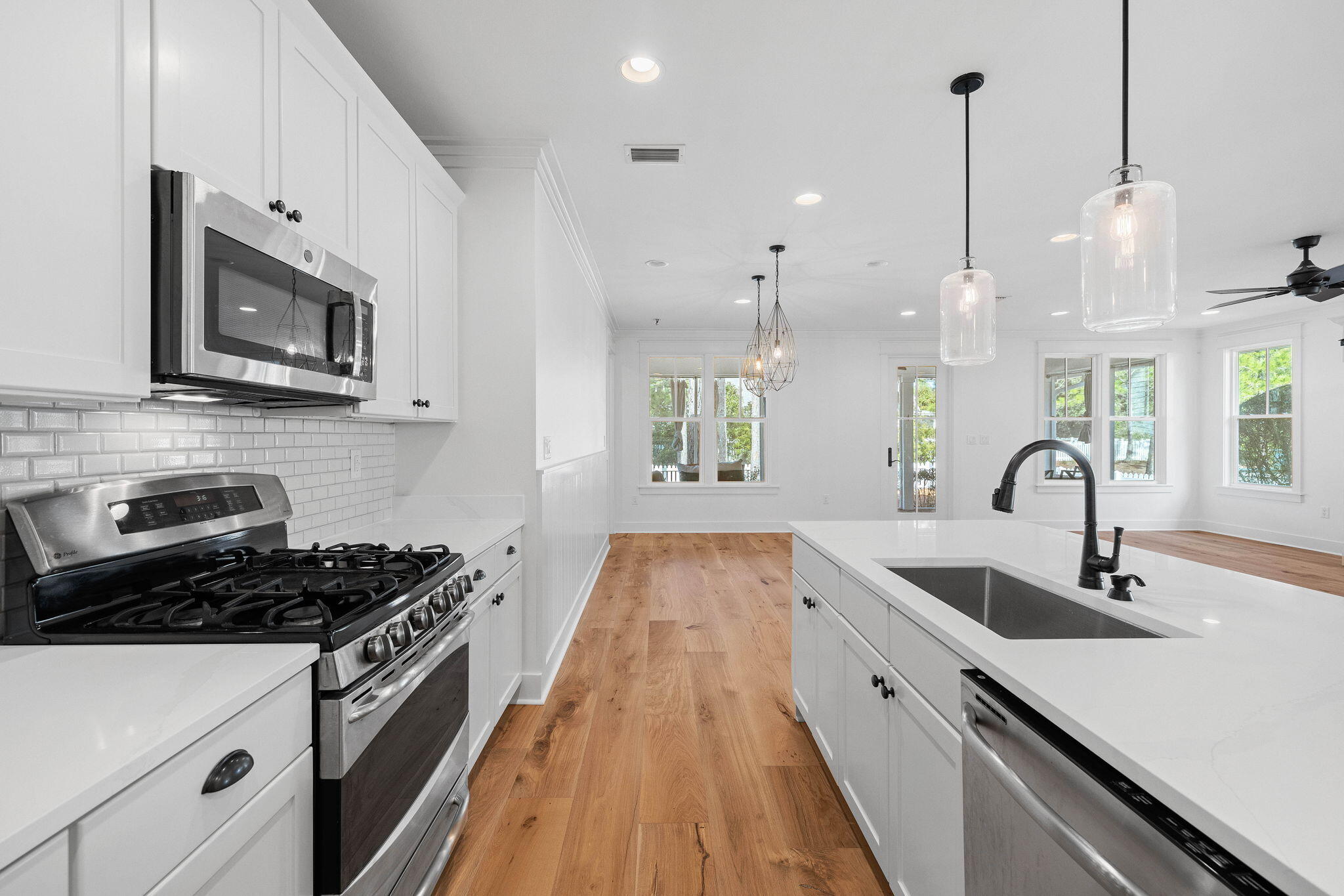 821 Breakers Street Inlet Beach, FL 32461 - Photo 31 of 69 a kitchen with stainless steel appliances granite countertop a sink a stove and a wooden floors