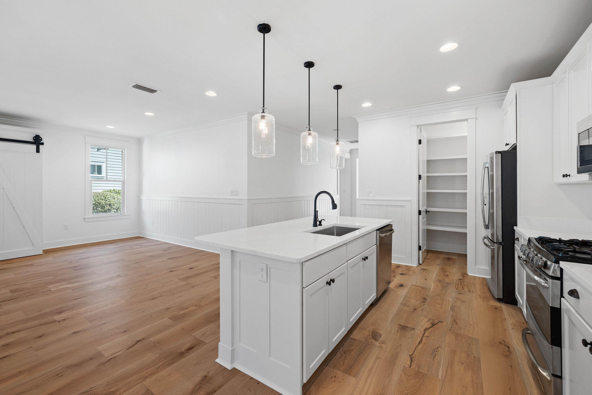 821 Breakers Street Inlet Beach, FL 32461 - Photo 34 of 69 a kitchen with stainless steel appliances granite countertop a sink a stove and a wooden floor