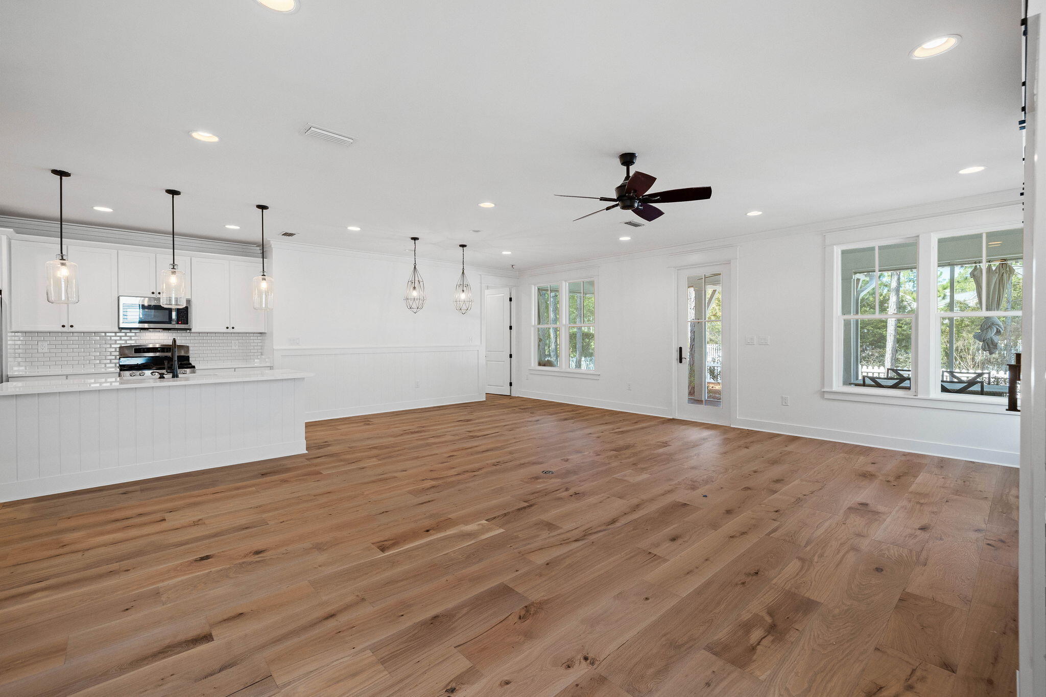 821 Breakers Street Inlet Beach, FL 32461 - Photo 50 of 69 a view of an empty room with kitchen view and wooden floor