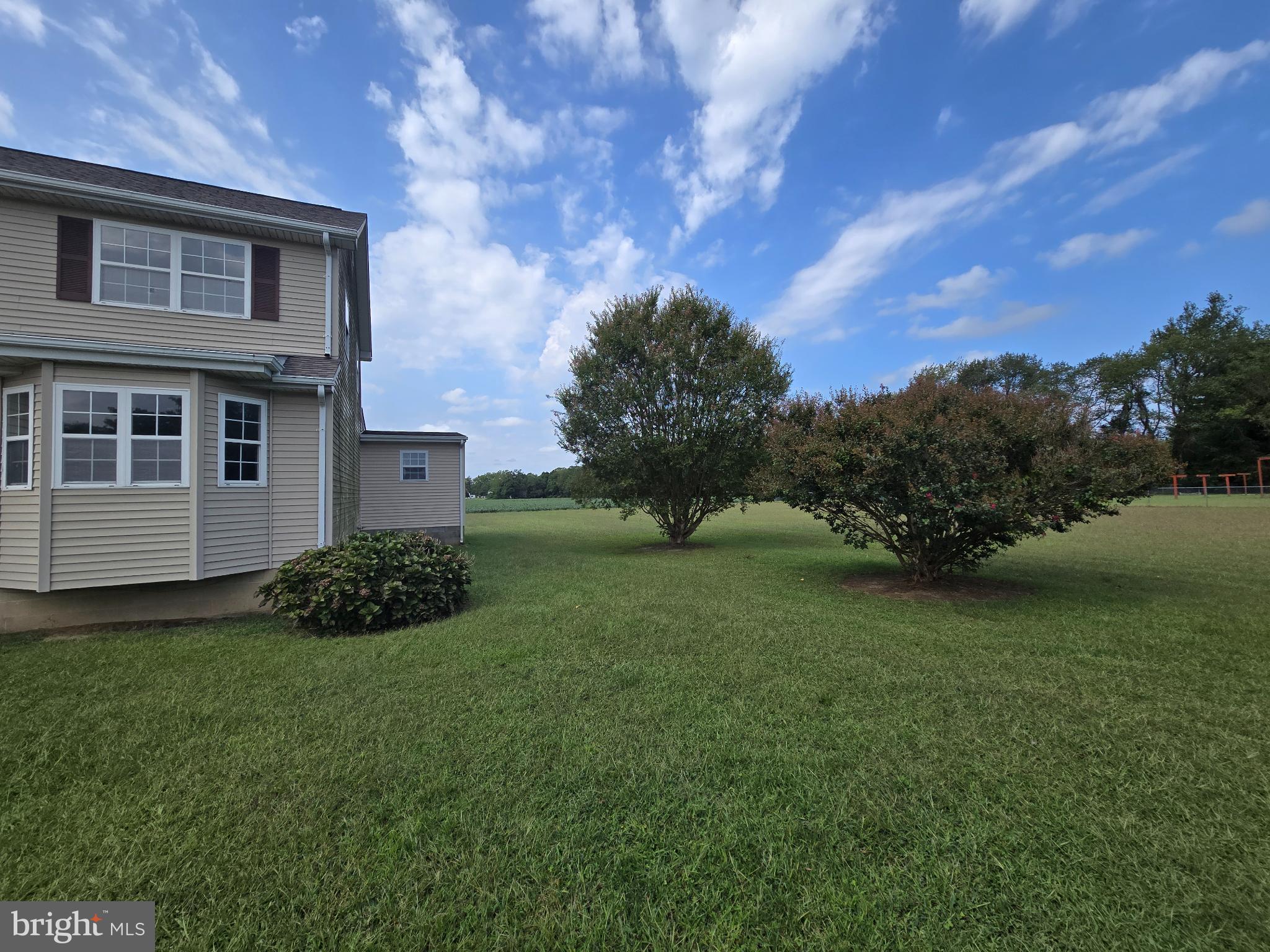 8806 Greentop Road Lincoln, DE 19960 - Photo 34 of 35 Spacious yard under a bright blue sky.