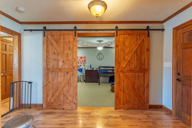 a living room with furniture a piano and a bookshelf