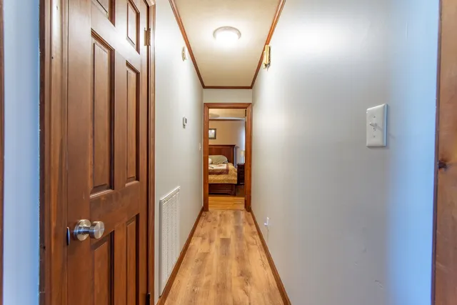 a bedroom with a large bed and a chandelier