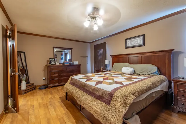 a spacious en suite bathroom with a granite countertop sink and a mirror