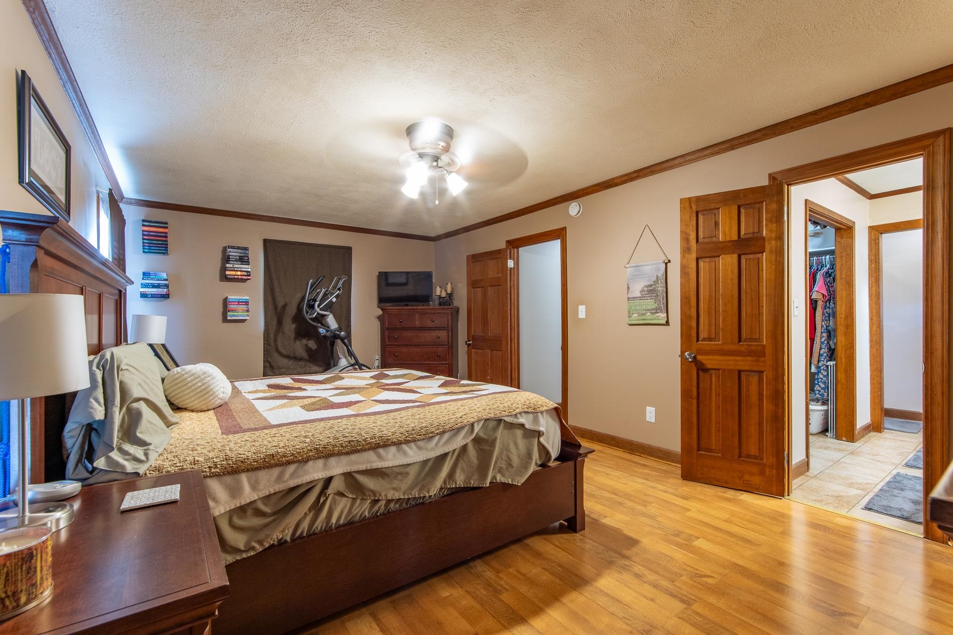 255 Easley Loop Savannah, TN 38372 - Photo 20 of 40 a bedroom with a large bed and a chandelier