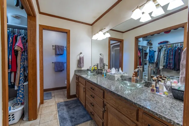 a kitchen that has a sink a stove and cabinets