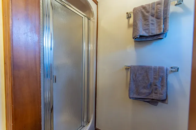 a bathroom with a granite countertop toilet sink and mirror