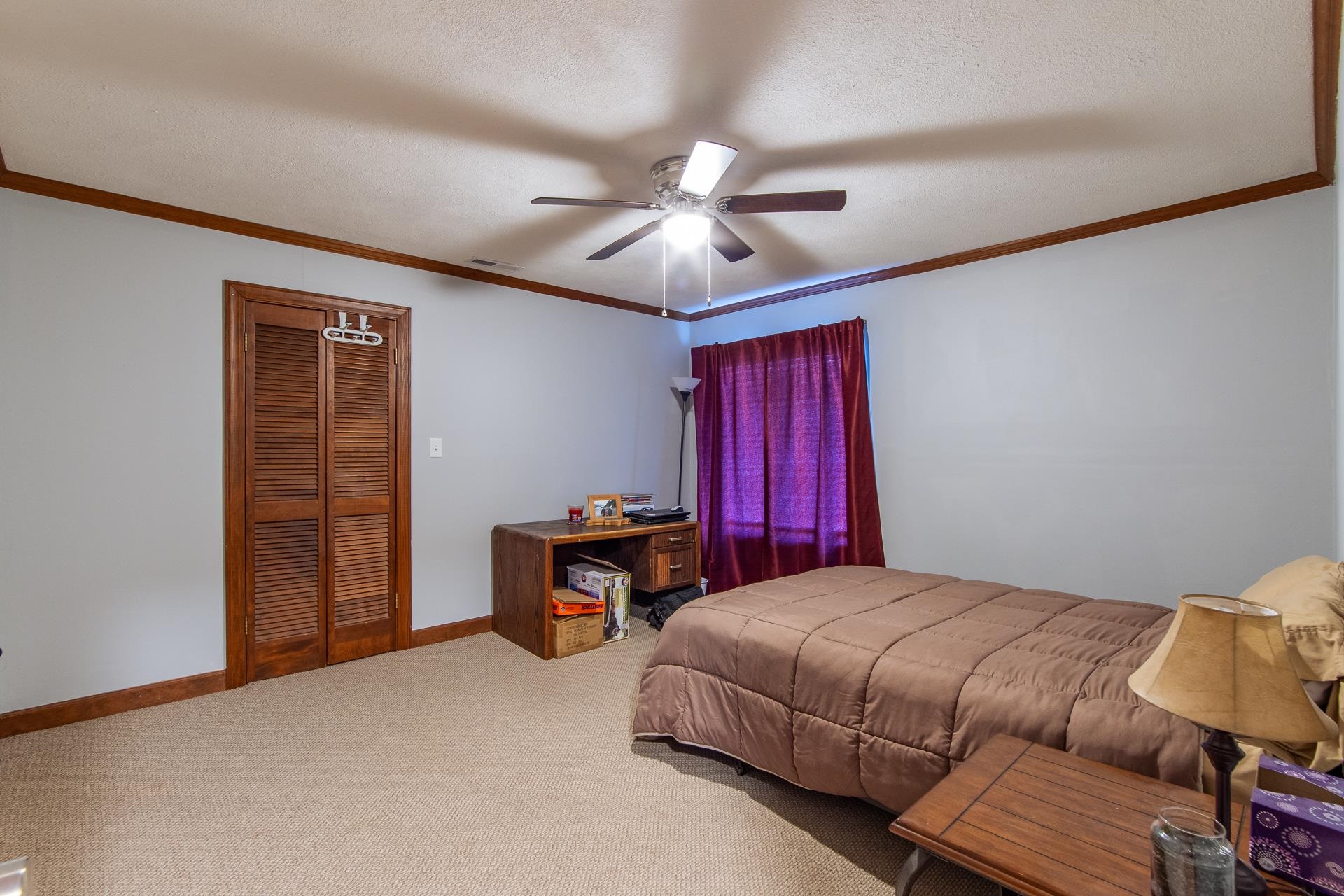 255 Easley Loop Savannah, TN 38372 - Photo 28 of 40 a bedroom with a bed and a chandelier