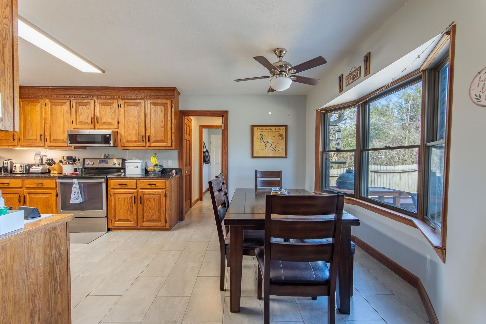 255 Easley Loop Savannah, TN 38372 - Photo 9 of 40 a kitchen with a table chairs refrigerator and cabinets
