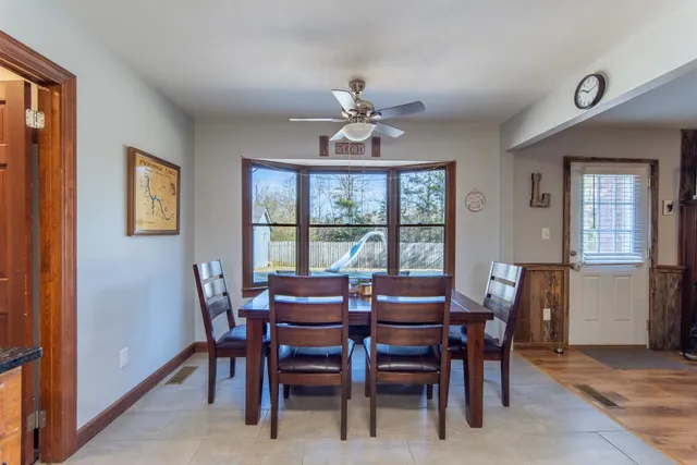 a kitchen with stainless steel appliances granite countertop a stove sink microwave and window