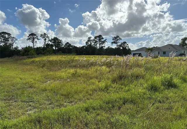 a view of a houses with yard in background