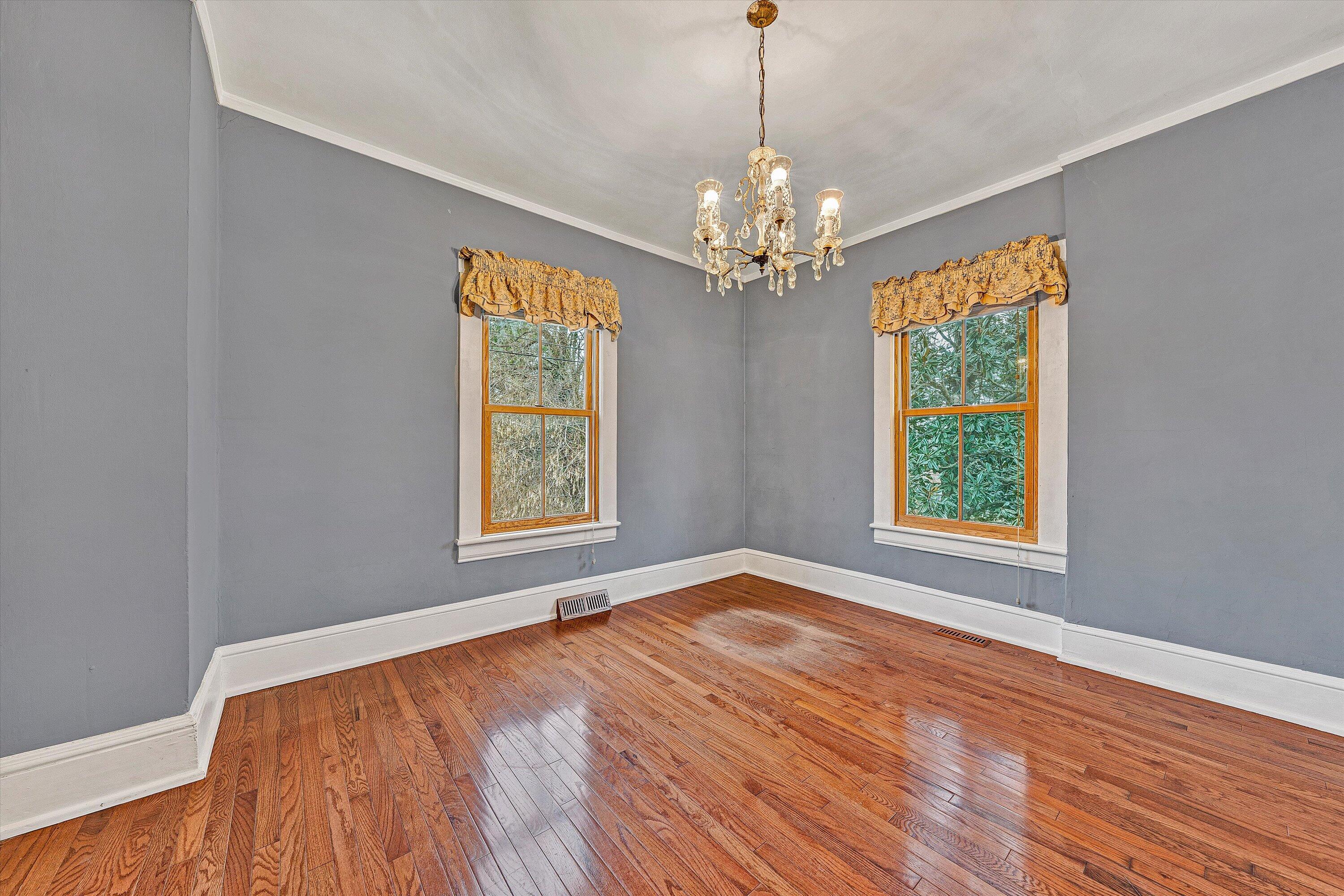 1609 6th Street Southwest Roanoke, VA 24016 - Photo 12 of 43 a view of an empty room with wooden floor and a window
