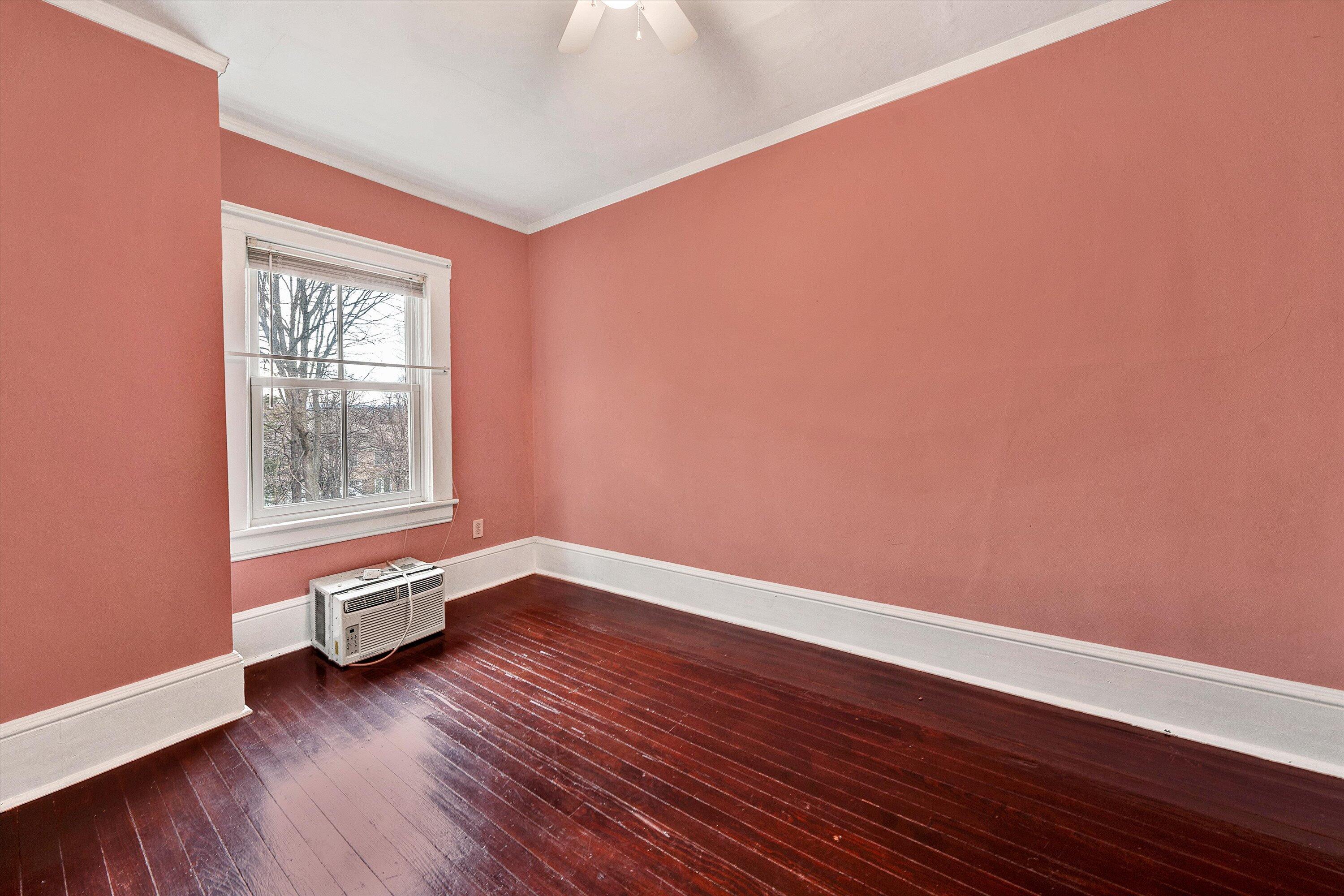 1609 6th Street Southwest Roanoke, VA 24016 - Photo 23 of 43 a view of an empty room with wooden floor and a window
