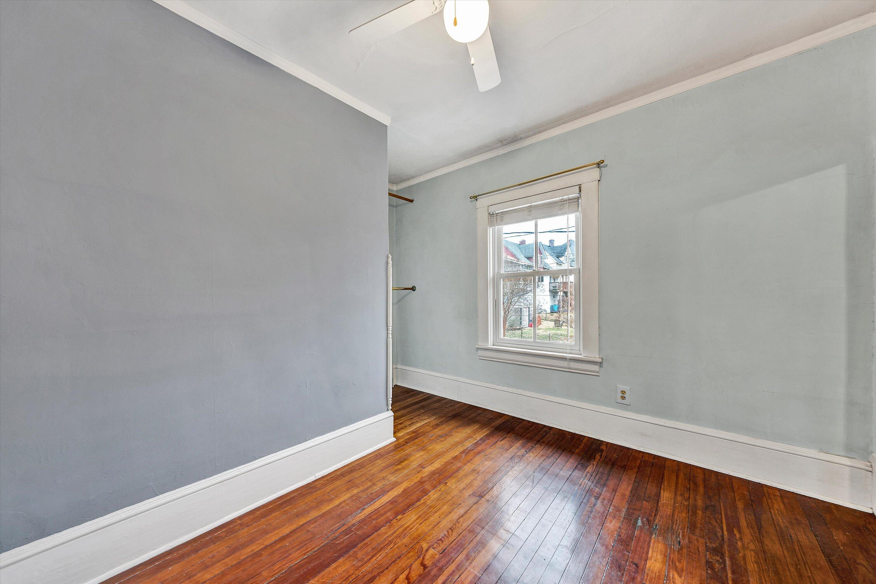 1609 6th Street Southwest Roanoke, VA 24016 - Photo 26 of 43 a view of an empty room with wooden floor and a window