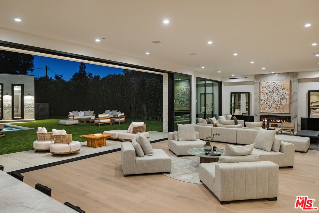 17055 Rancho Street Encino, CA 91316 - Photo 4 of 73 a living room with furniture and a large window