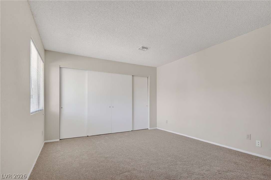 2241 Highpointe Drive, Unit 101 Laughlin, NV 89029 - Photo 20 of 23 This spacious bedroom offers ample natural light and generous closet space for comfortable living.