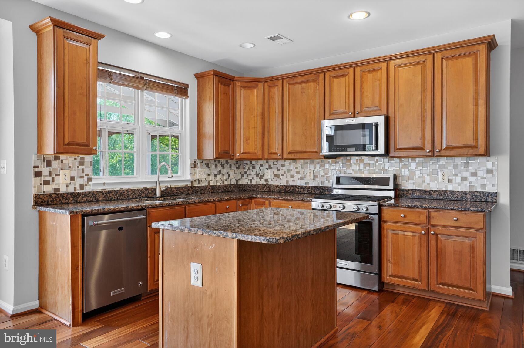 25845 Spring Farm Circle Chantilly, VA 20152 - Photo 11 of 57 Modern kitchen with rich wood accents.