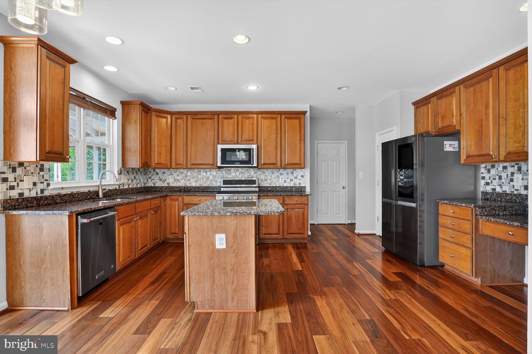 25845 Spring Farm Circle Chantilly, VA 20152 - Photo 13 of 57 Modern kitchen with rich wood accents.