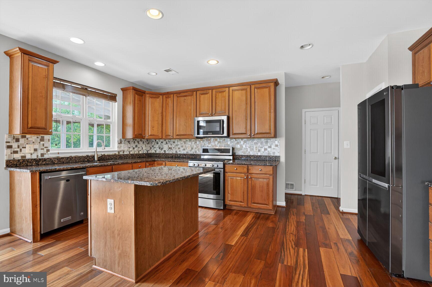 25845 Spring Farm Circle Chantilly, VA 20152 - Photo 14 of 57 Modern kitchen with rich wood accents.