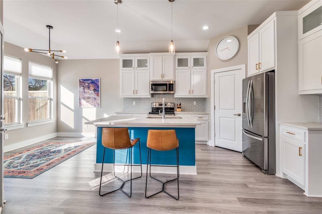1210 Morrell Avenue Dallas, TX 75203 - Photo 11 of 28 a kitchen with granite countertop a refrigerator and a stove top oven