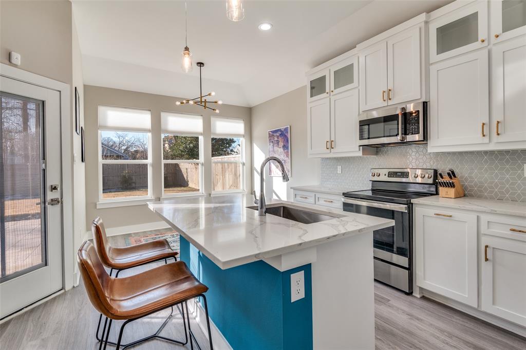 1210 Morrell Avenue Dallas, TX 75203 - Photo 12 of 28 a kitchen with stainless steel appliances granite countertop a stove a sink and a refrigerator