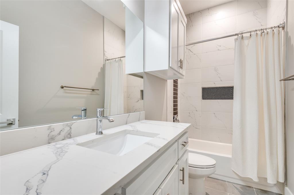 1210 Morrell Avenue Dallas, TX 75203 - Photo 19 of 28 a bathroom with a sink a toilet and shower