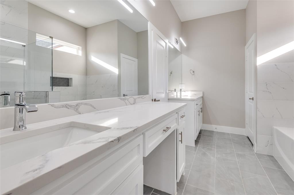 1210 Morrell Avenue Dallas, TX 75203 - Photo 24 of 28 a bathroom with double vanity sinks and a bathtub