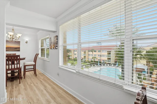 a view of a room with furniture and wooden floor
